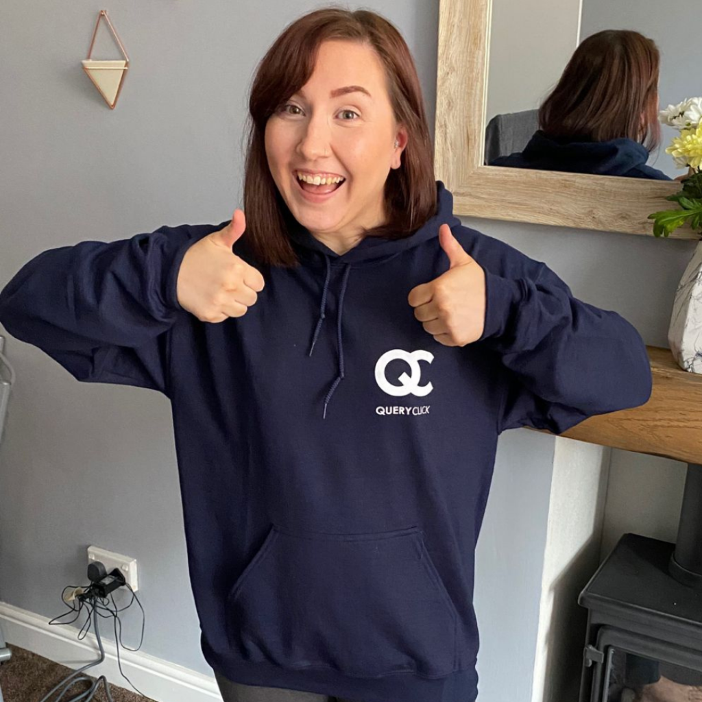 New QC employee, Laura, showing off her QC hoodie.